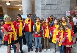 Charter school students showing of their school choice week scarves