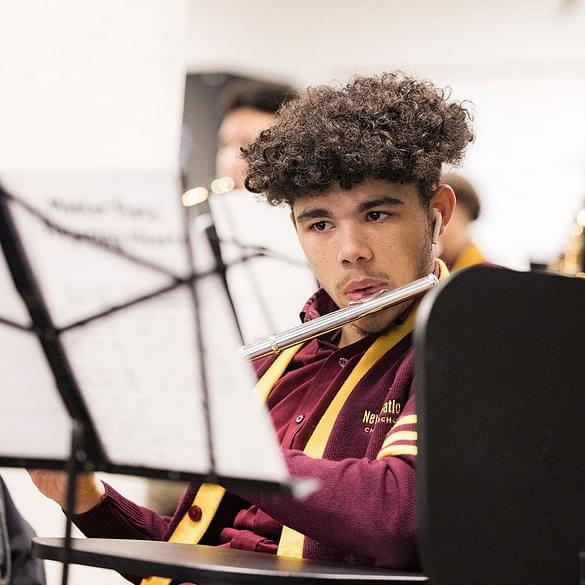  student playing xylophone during music class 