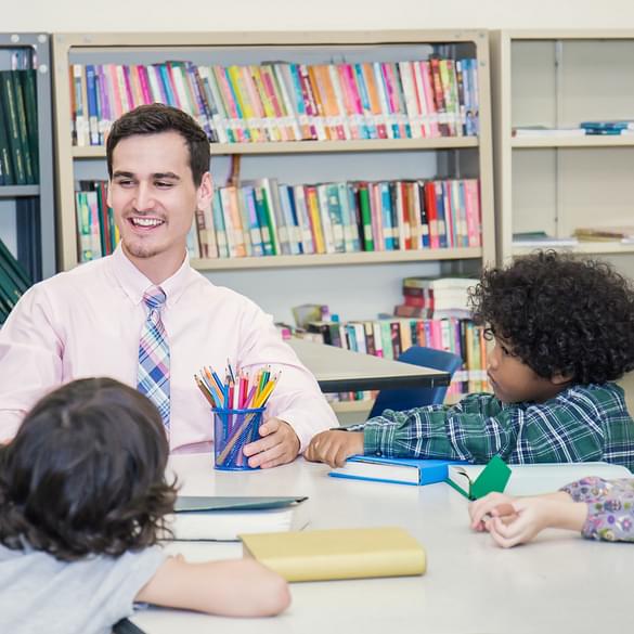  Students at table with teacher 