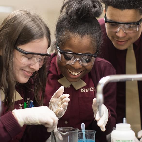 3 students conducting a science experiment