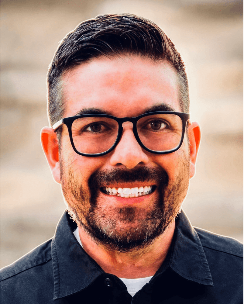 ewhite male with black framd glasses and black hair and black facial hair