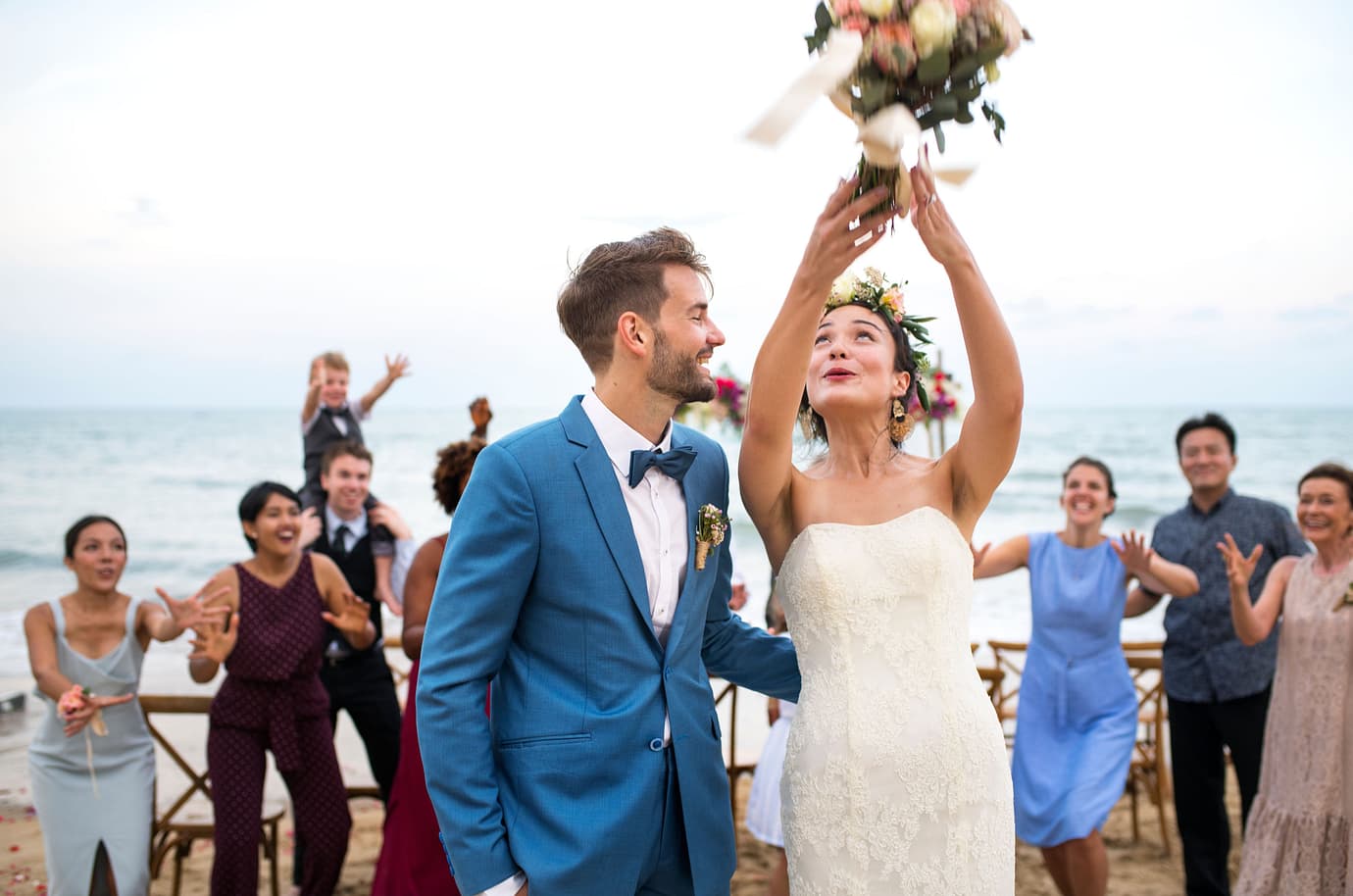 Couple throwing a bouquet at their destination wedding