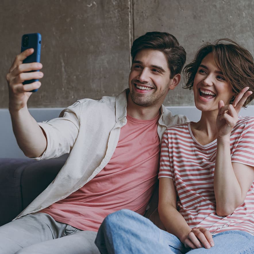 Couple watching their online wedding video