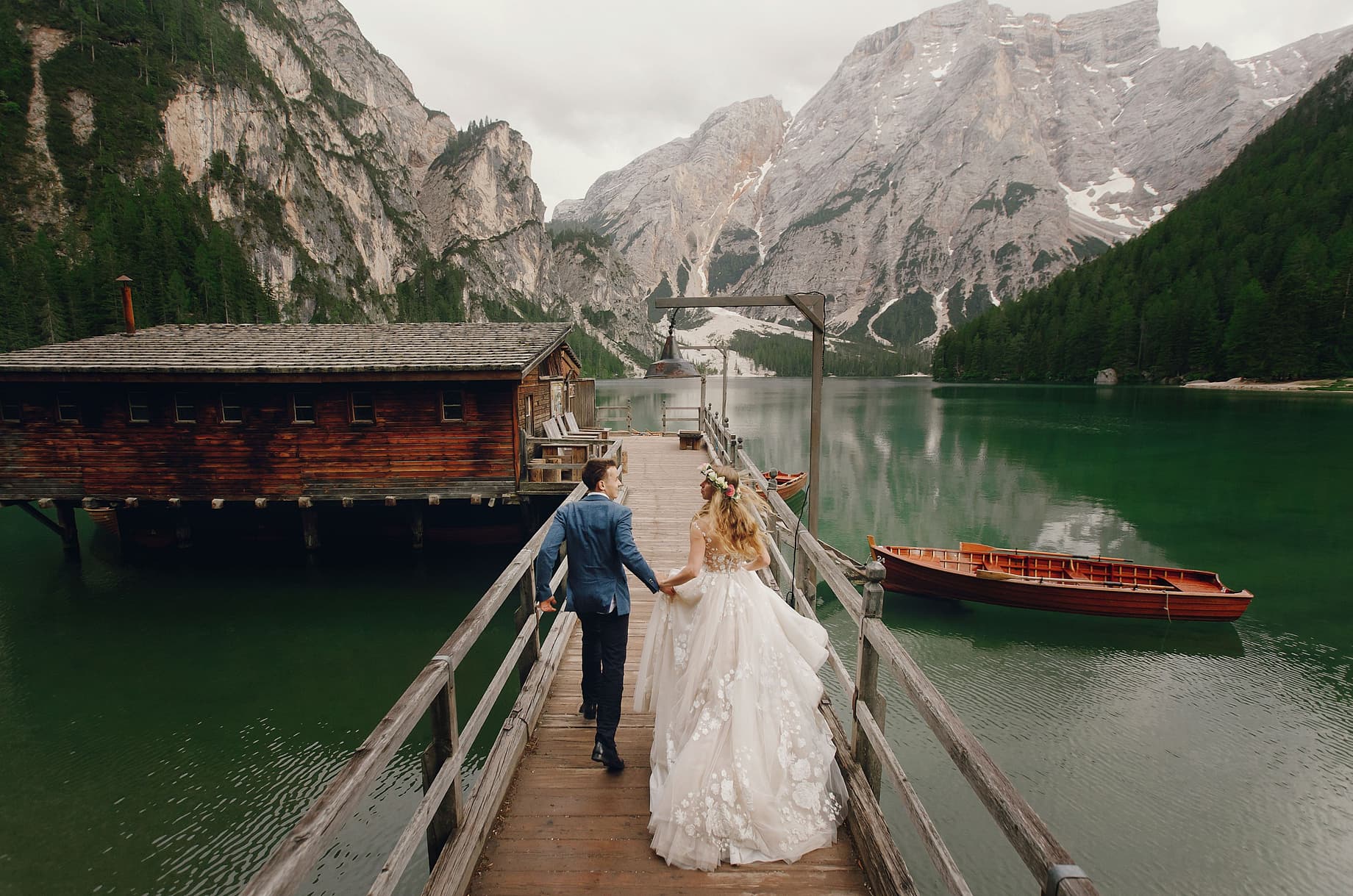 Married couple walking along a pier