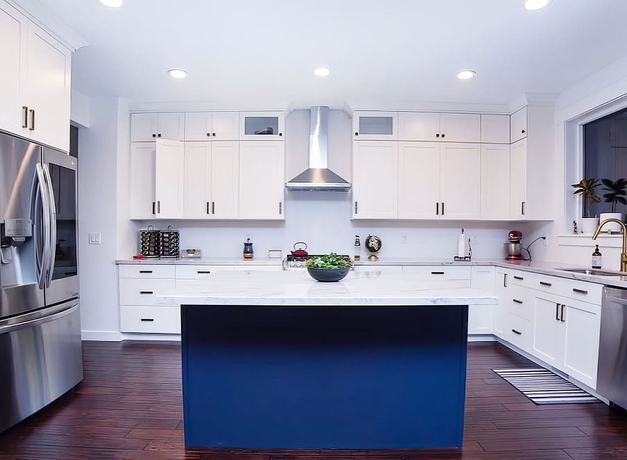 Kitchen with white cabinets and accent island