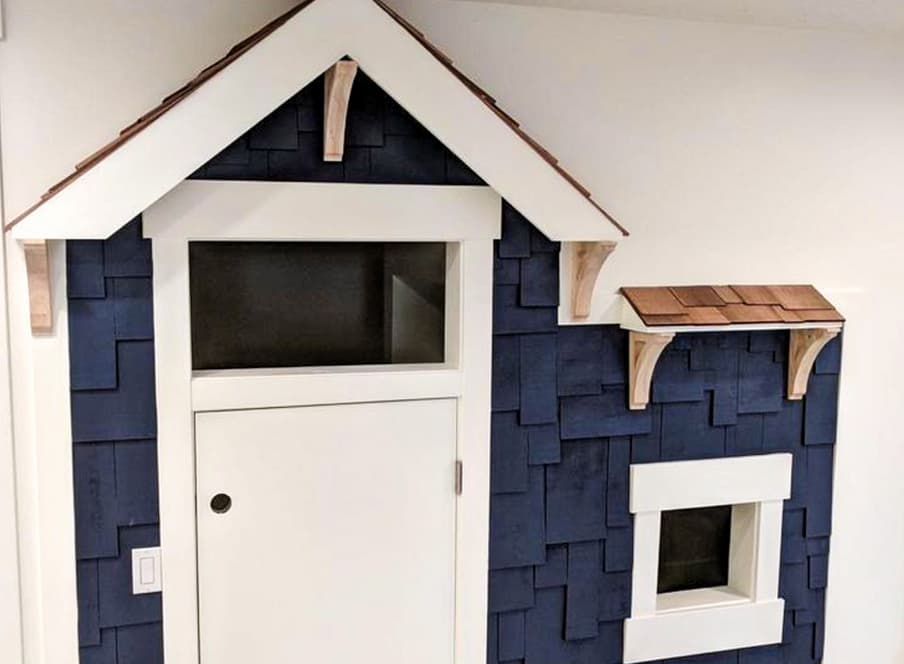 Playhouse build-in under the stairs with beach shingles