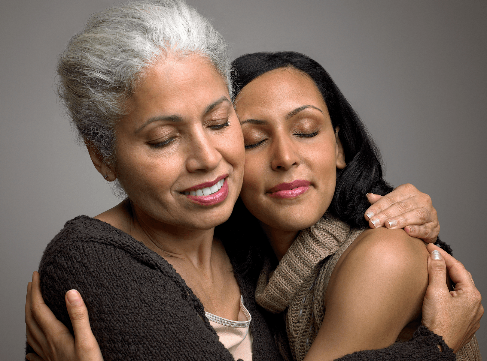 Grandmother and daughter embracing.