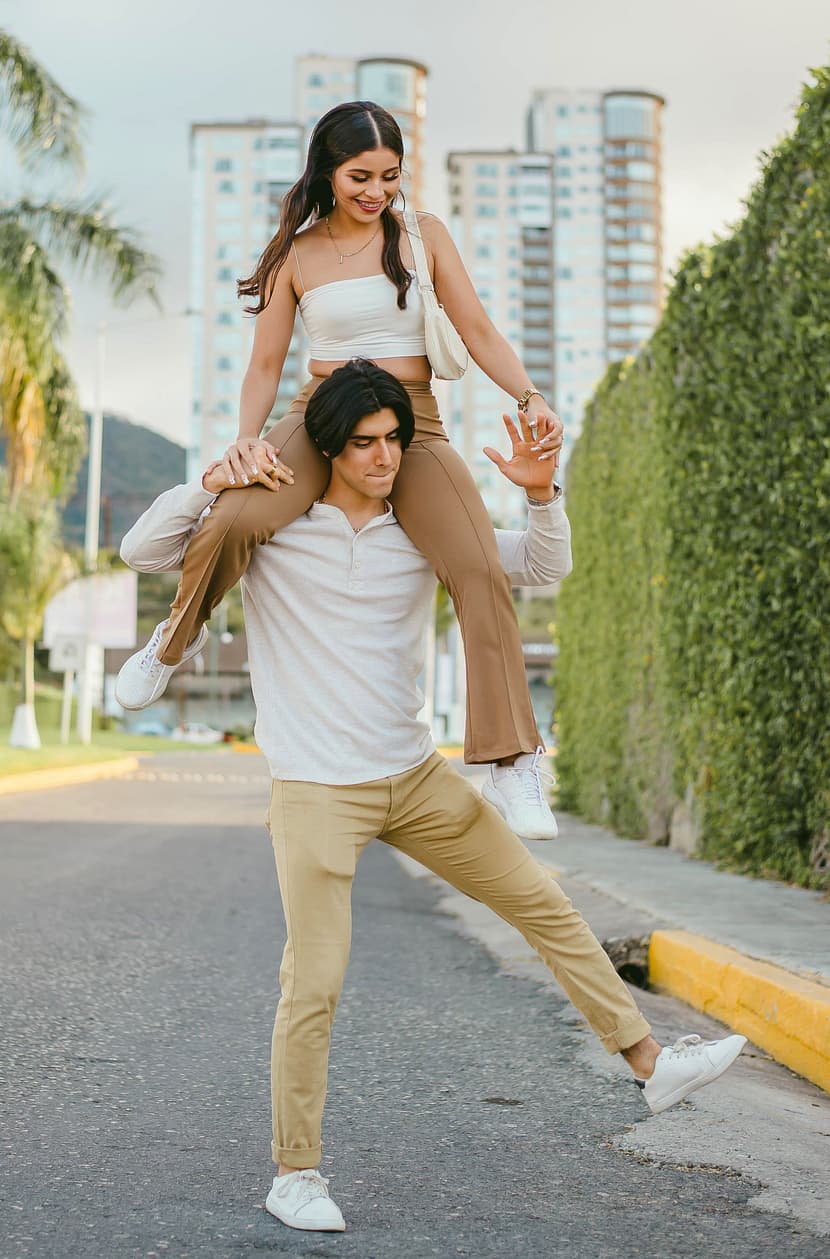 Woman rides on a man's shoulders