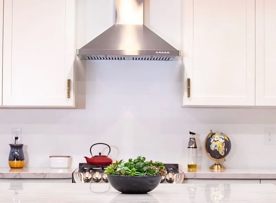 Kitchen with stainless hood