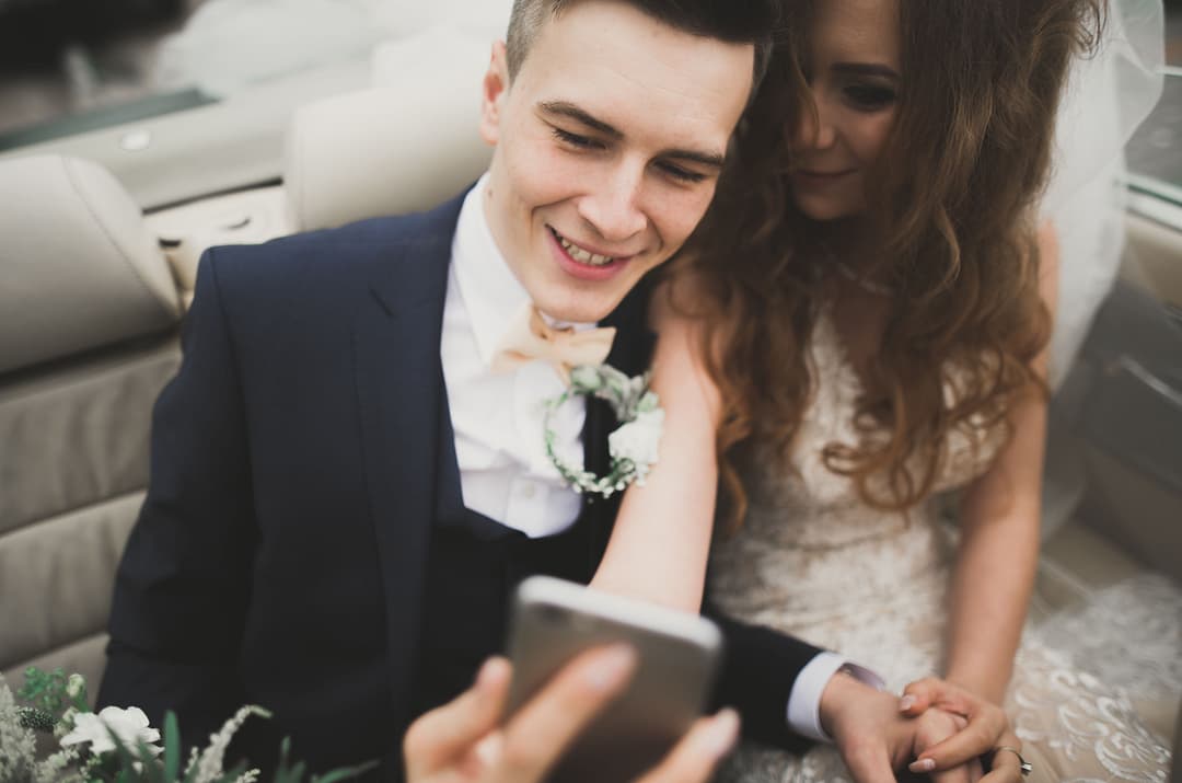 Couple smiles during their online wedding ceremony