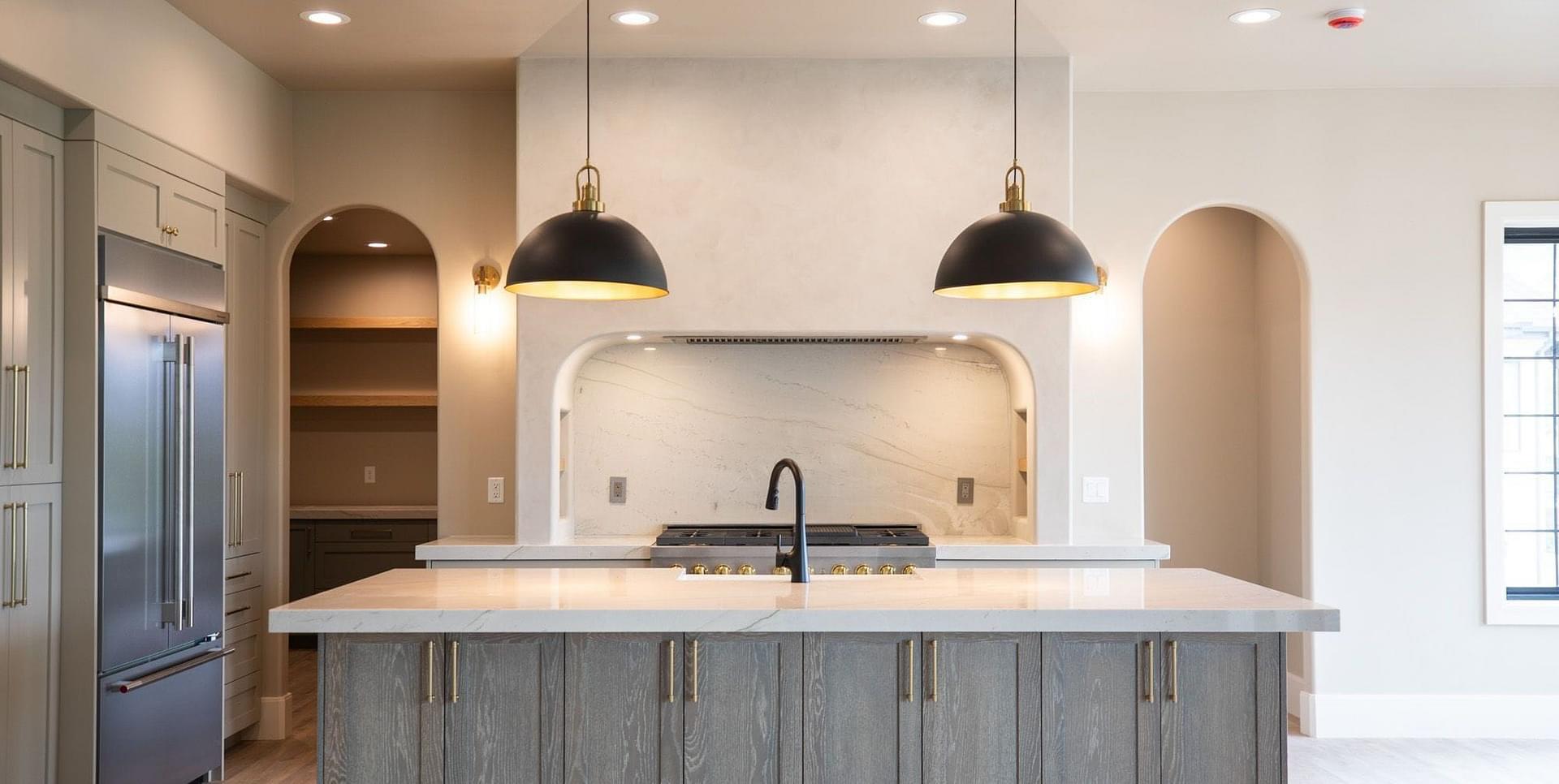 Custom kitchen with large island with storage in the Springbrook home in Midway, Utah