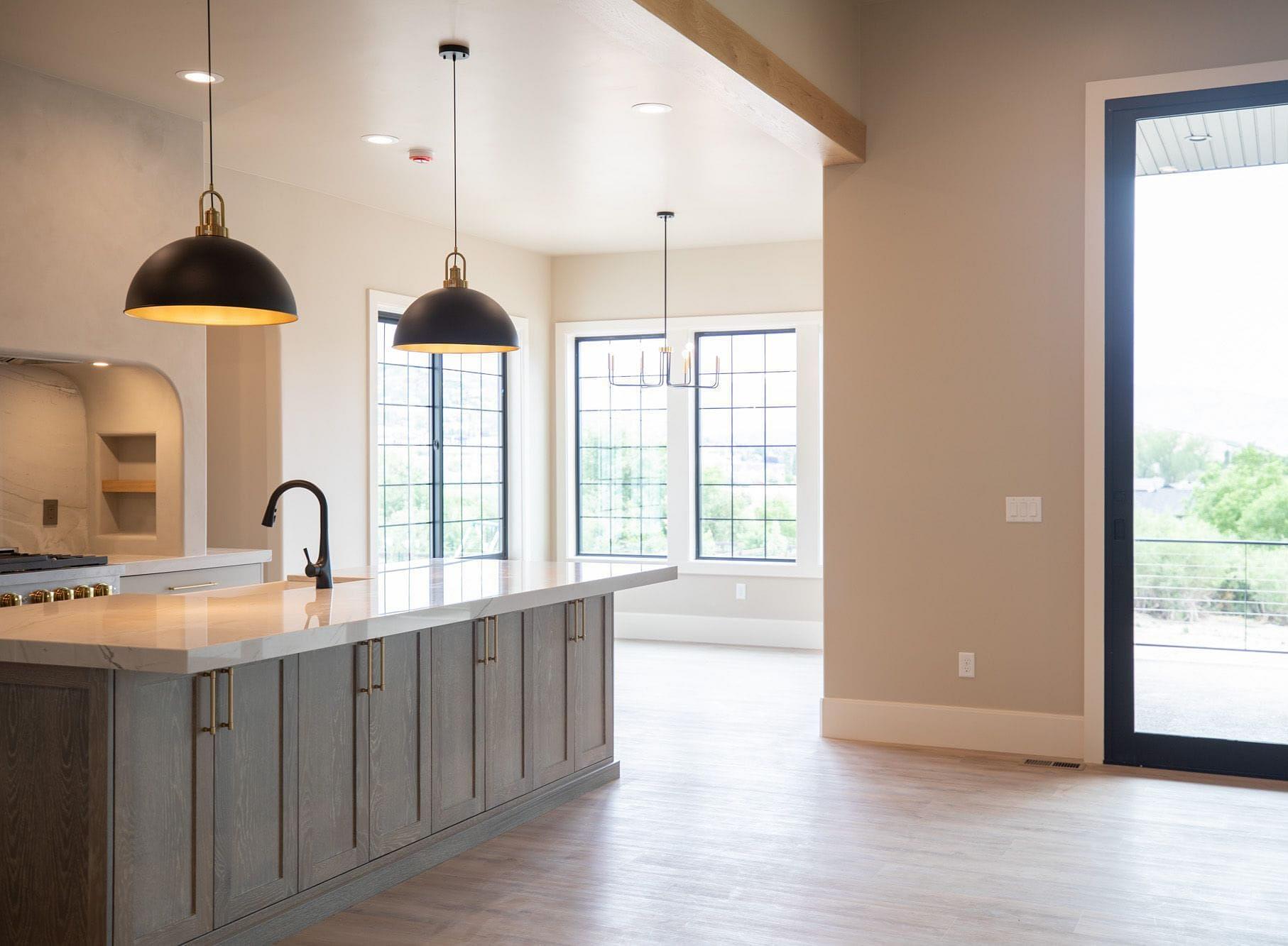 Open concept kitchen with large island in the Springbrook home in Midway, Utah
