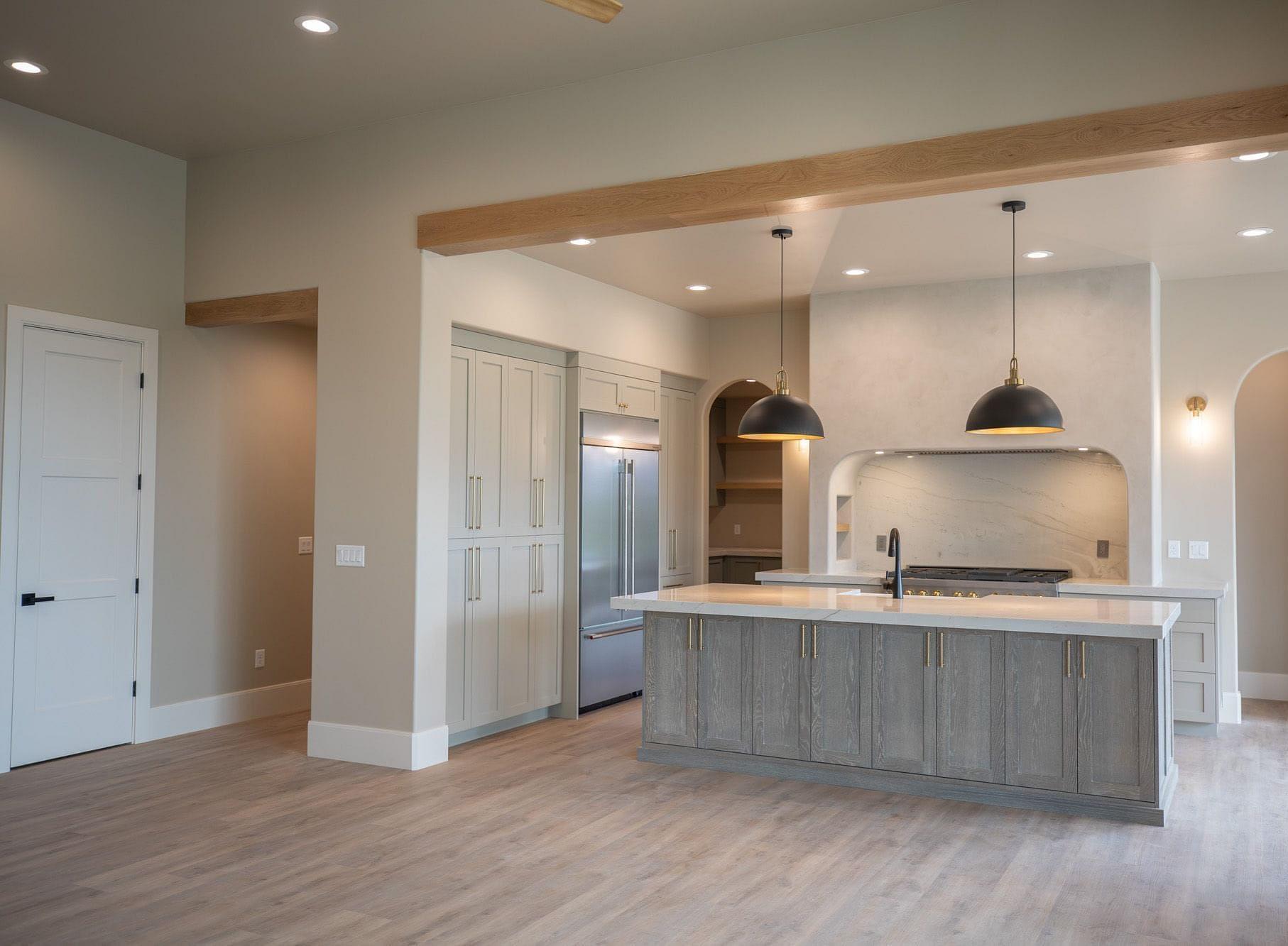 Open concept kitchen with large island in the Springbrook home in Midway, Utah