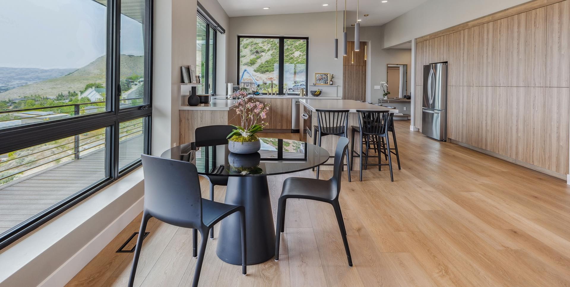 Open dining and kitchen area with large windows and mountain views in Salt Lake City.