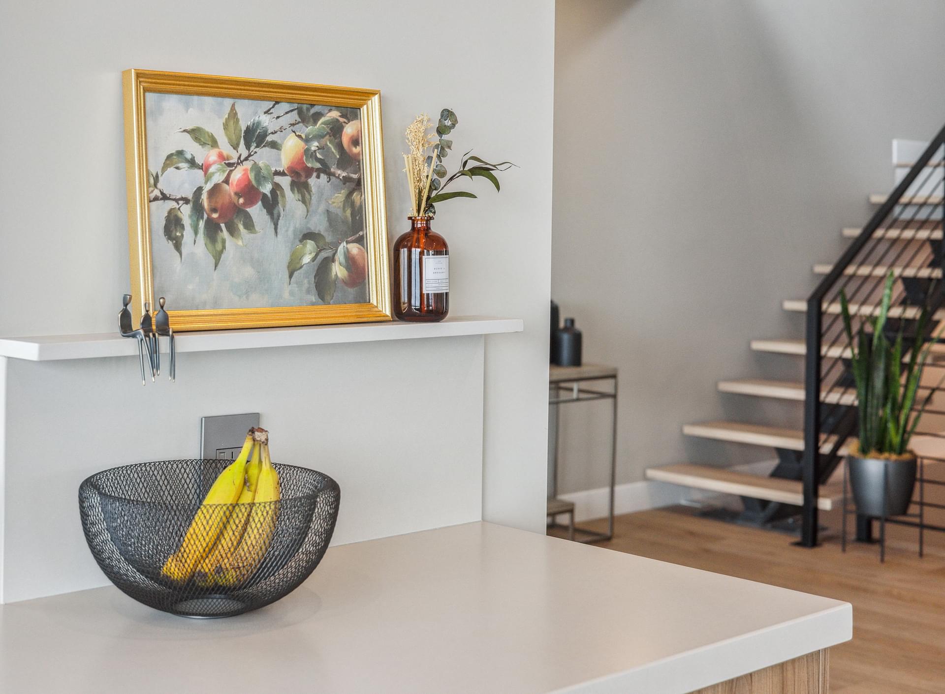 Entry area with floating console, artwork, and modern staircase.