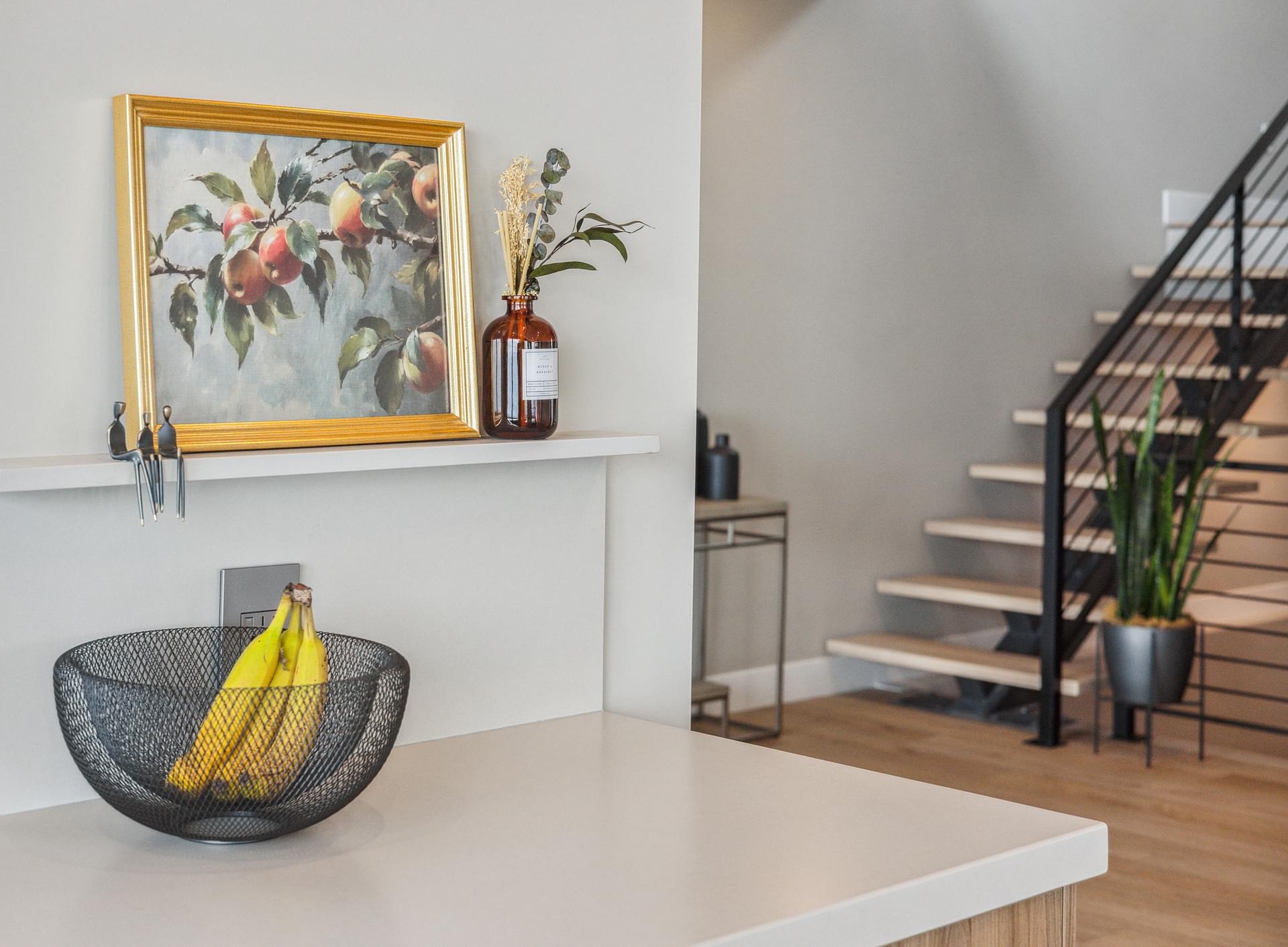 Entry area with floating console, artwork, and modern staircase.