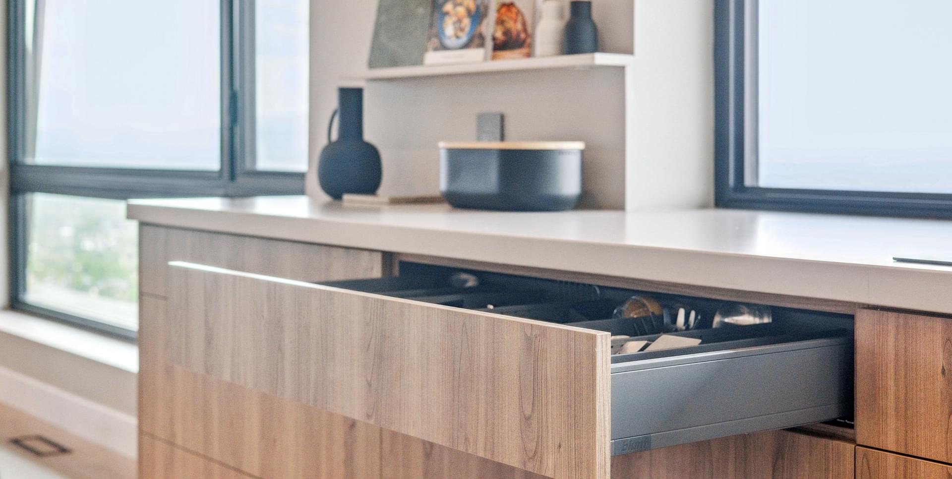 Wood kitchen island with waterfall countertop and built-in storage.