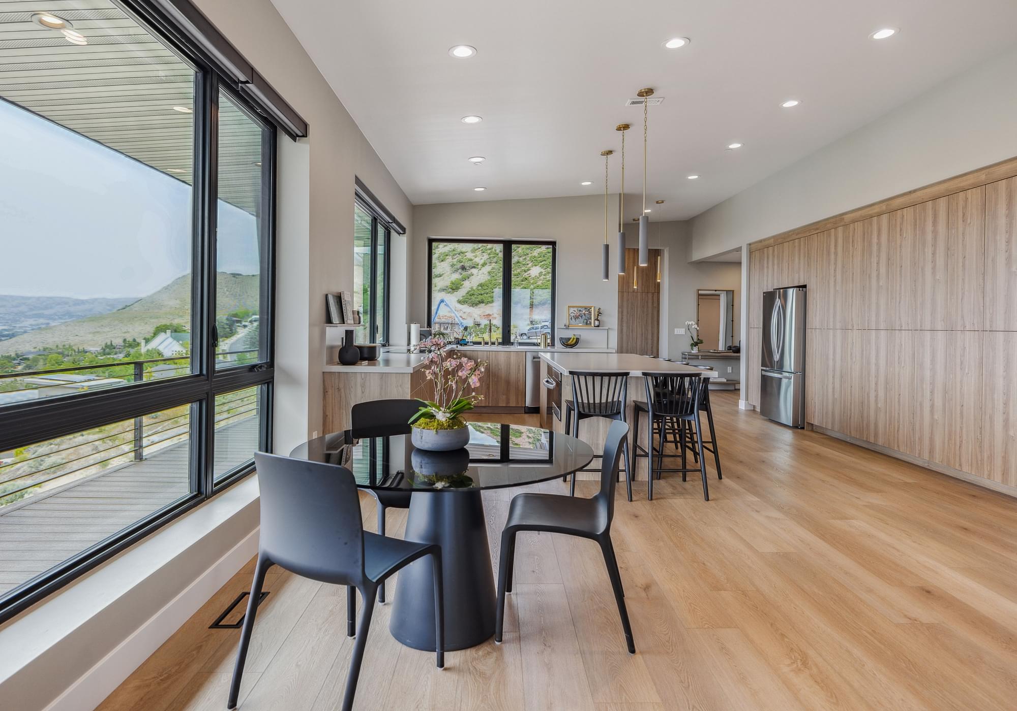  Open-concept kitchen with large island, custom cabinetry, and mountain views in the East Bench residence of Salt Lake City. 