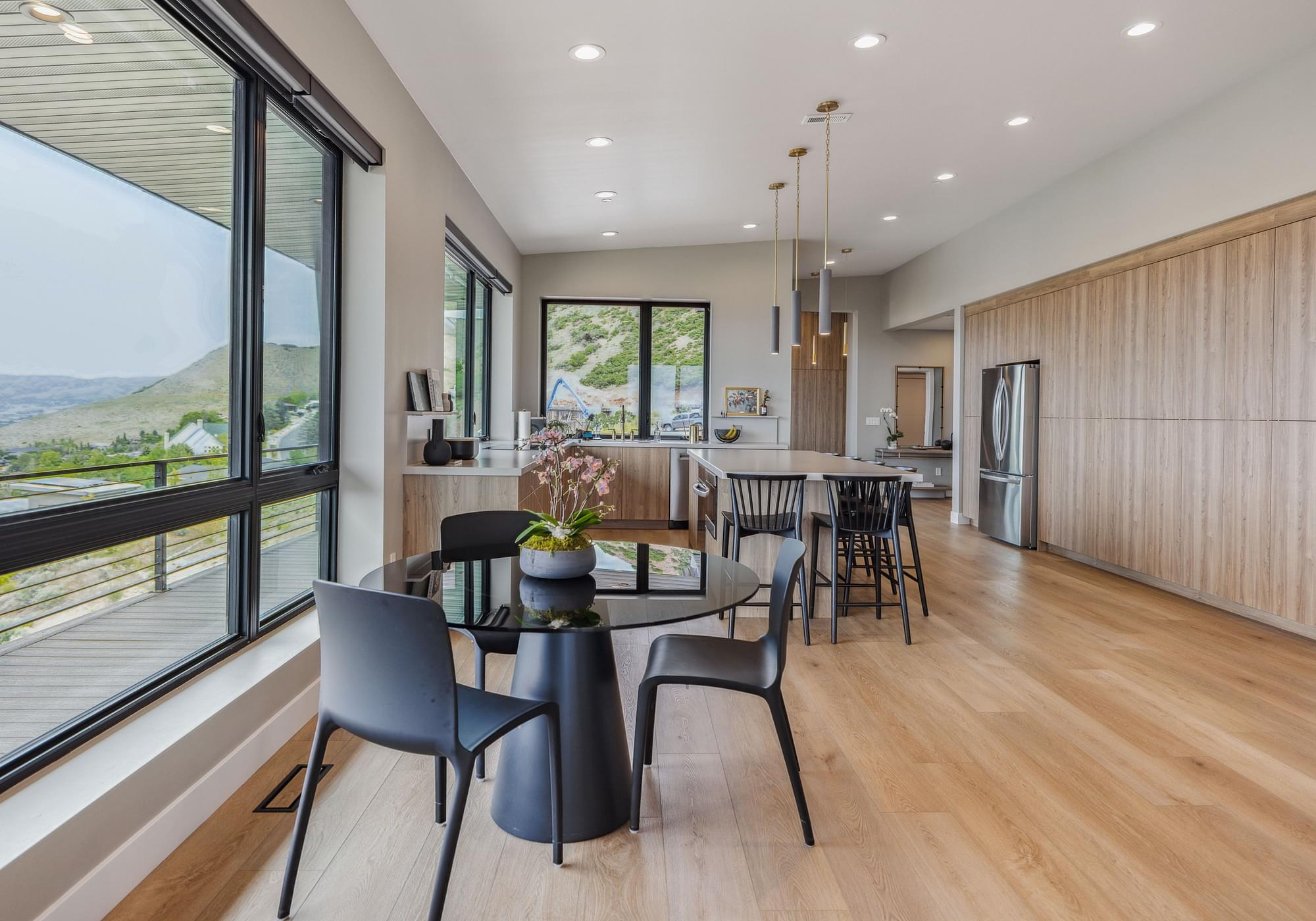  Open-concept kitchen with large island, custom cabinetry, and mountain views in the East Bench residence of Salt Lake City. 