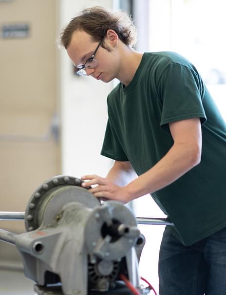 Plumbing student working in his career field