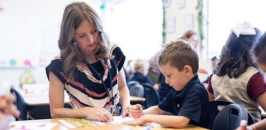  Teacher helping a kindergarten student 