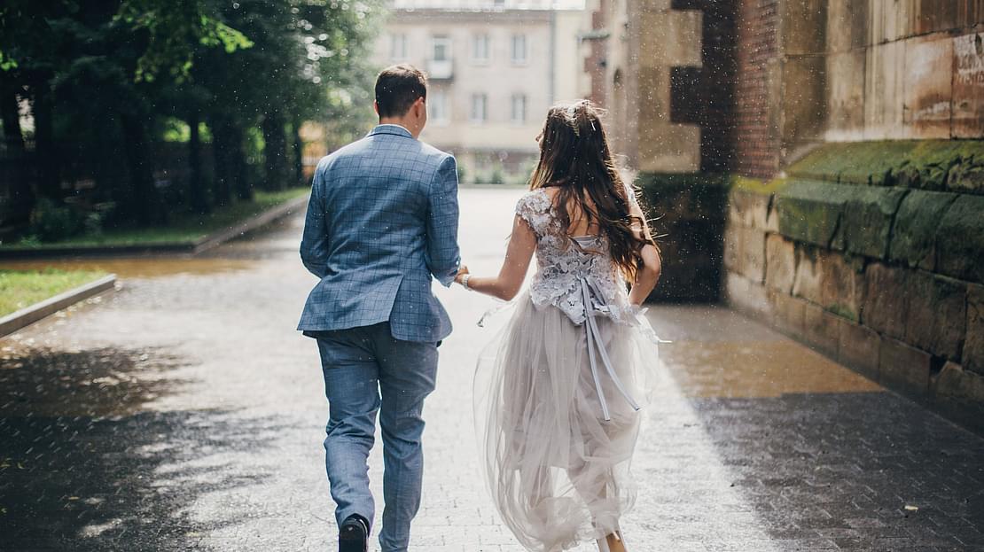 Couple running in the rain