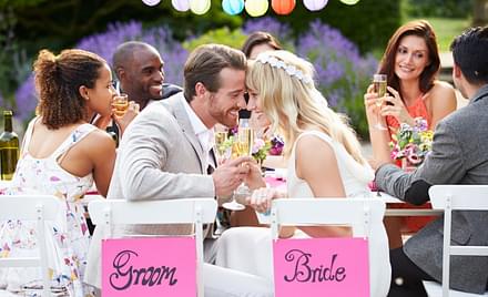 Bride and groom sharing a drink at their wedding