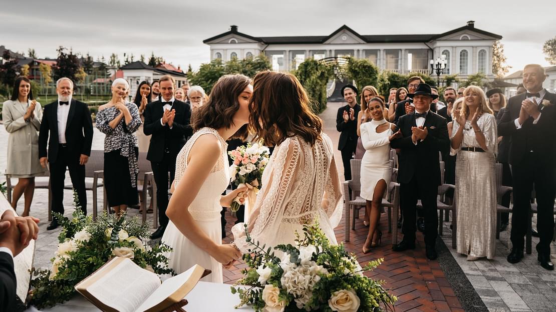 Same-sex couple kissing at their wedding