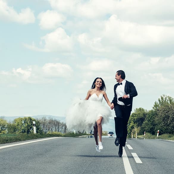 Married couple running in the street