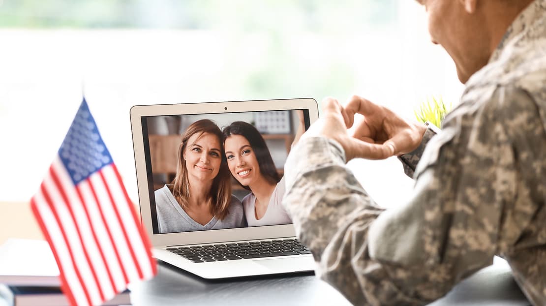  Military couple getting married online with family and friends on video call 