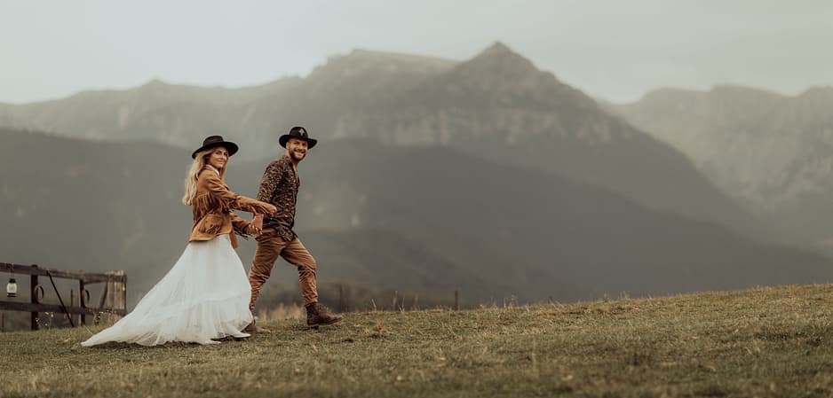 Couple walking in the scenic mountains after getting married