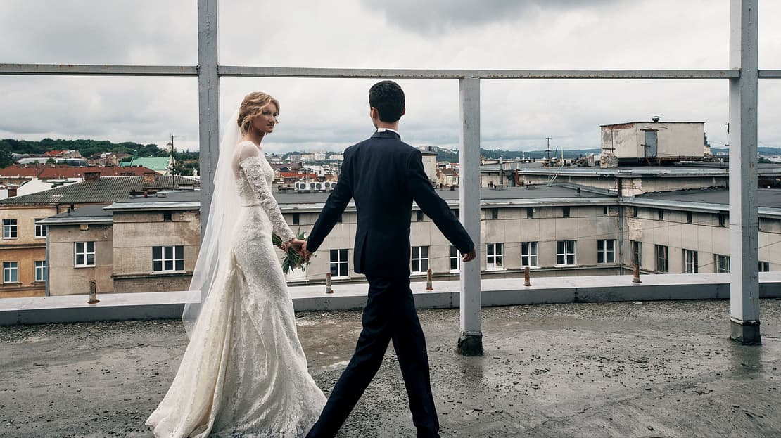  Married couple walking along a rooftop 