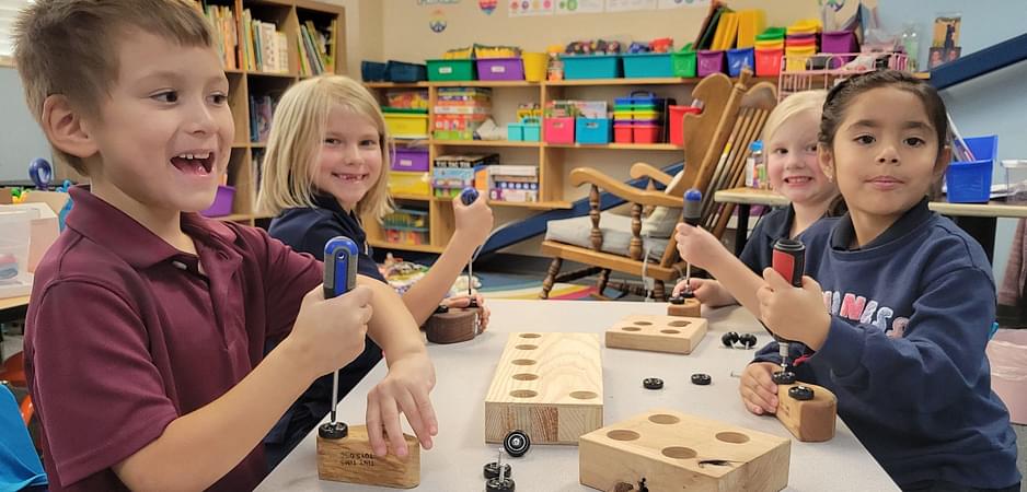 Students putting wheels on wood cars