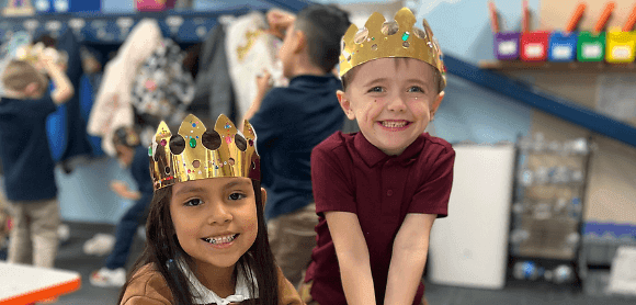 Two kids wearing crowns