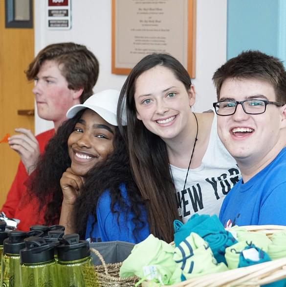 A diverse group of smiling students in a close-knit setting, representing the strong sense of community and positive relationships fostered by student lead clubs at Career Path High. This image illustrates the  fun activities that contribute to a feeling of belonging for every student.