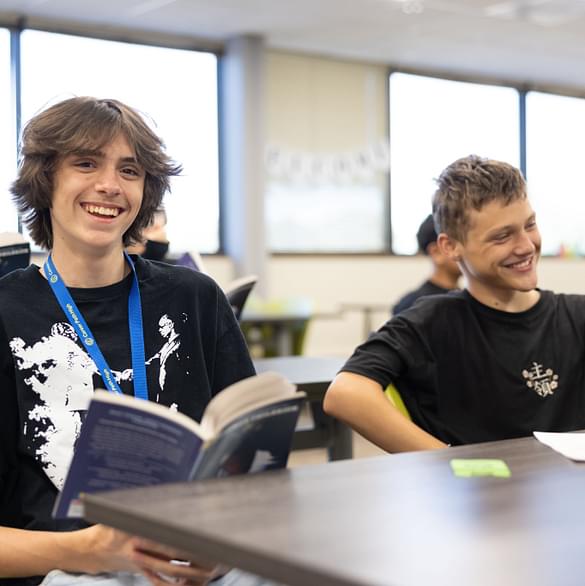 Smiling students in a classroom, representing the hope and clear 'pathway forward' that Career Path High provides, especially for students who may not have seen a future plan before. This image captures the positive atmosphere of a small school where students find belonging and are set up for success in their chosen career path